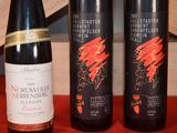 three bottles of wine sitting on a table next to each other