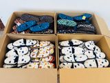 two boxes of slippers that are sitting on the floor