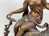a statue of a woman sitting on top of a horse