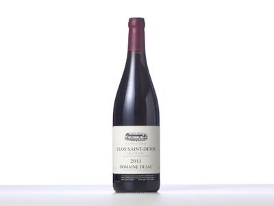 a bottle of red wine sitting on top of a table
