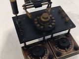 a small black and gold clock on top of a table