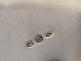 a close up of a silver plate with coins on it