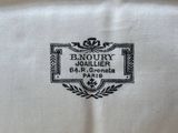 a close up of a white table cloth with a black and white label