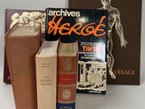 several books are stacked on top of each other on a table