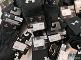 a pile of black and white socks with tags on them