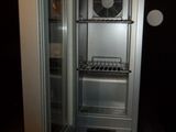 an open refrigerator with a fan inside of it