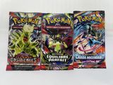 three packs of pokemon trading cards on a white background