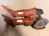 pair of red and black hand tools sitting on top of a white surface