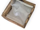 a small wooden box with a sheet of paper inside of it