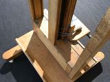 a picture of a wooden stand with a pair of scissors on it