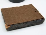 a piece of brown paper sitting on top of a white table
