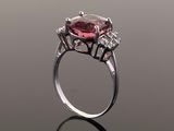 a close up view of a pink tourmaline and diamond ring