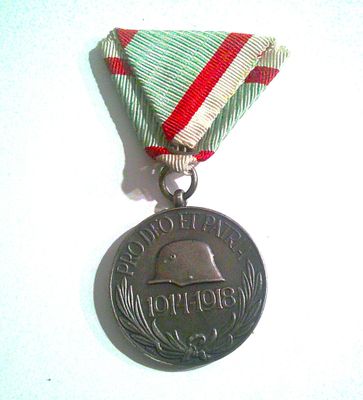 a silver medal with a red and white ribbon around it