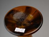 a brown glass vase with a label on it