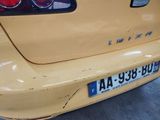 a close up of a yellow car with a license plate on it