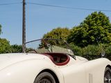 a white sports car parked on the side of the road