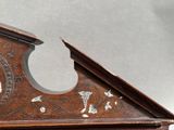 a wooden clock that is on display on a table