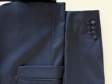 the suit is blue and has a black lapel on the lapel