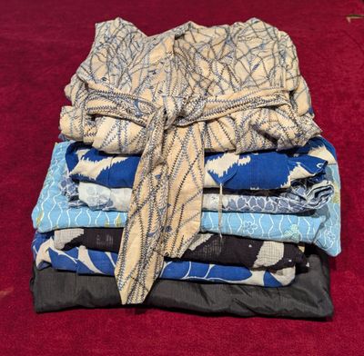 a stack of folded cloths on a red surface