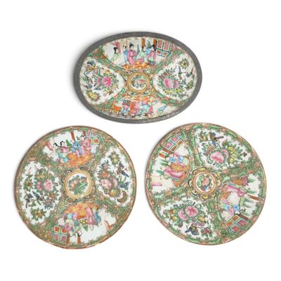 three plates with floral designs on them sitting on a white surface
