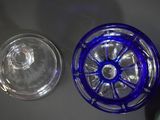 a blue glass bottle and a clear glass bowl on a table
