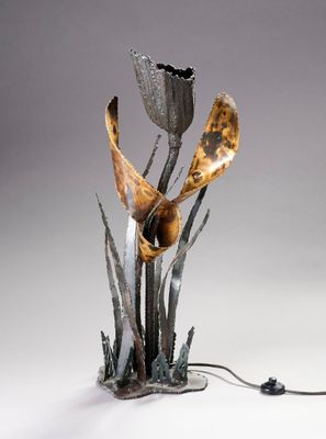 a metal sculpture of a flower on a table