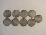 a lot of coins sitting on a white surface