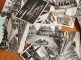 several black and white photos of a table with a bunch of postcards