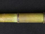 a close up of a metal tube on a black surface