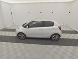 a picture of a small white car parked in a garage