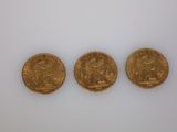 three gold sovereigns, one of which is a sovereign and one of which is a sovereign