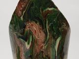green and brown marble sculpture on a white surface with a white background