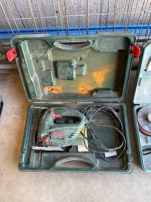 two tools in a green case sitting on the floor