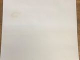 a piece of paper on a table with a roll of paper