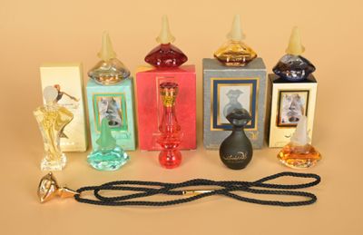 many different perfume bottles and a lanyard on a table