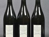 three bottles of wine sitting on top of a table next to each other