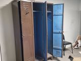 two lockers in the middle of a room with a chair in the corner