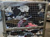 a large metal cage filled with many pairs of shoes
