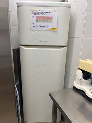 a refrigerator and a blender in a small kitchen
