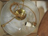 a glass bowl with a rope on it next to a toilet