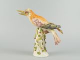 porcelain figurine of a bird perched on a tree branch