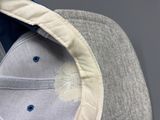 a close up of a baseball cap with a flower on it