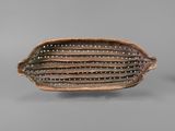 a close up of a brown and white bowl on a gray surface