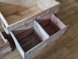 two wooden boxes that are open on the floor