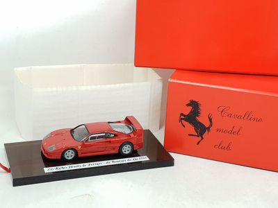 the red ferrari model is in a red box next to a red box