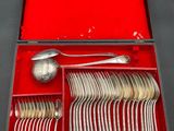 a red box with silverware in it on a table