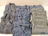 several pairs of men ' s clothing are laid out on a table