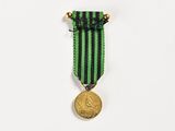 a close up of a medal on a white surface