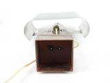 a small wooden box with a metal handle on a white surface