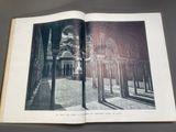 an open book with a picture of a building in the background